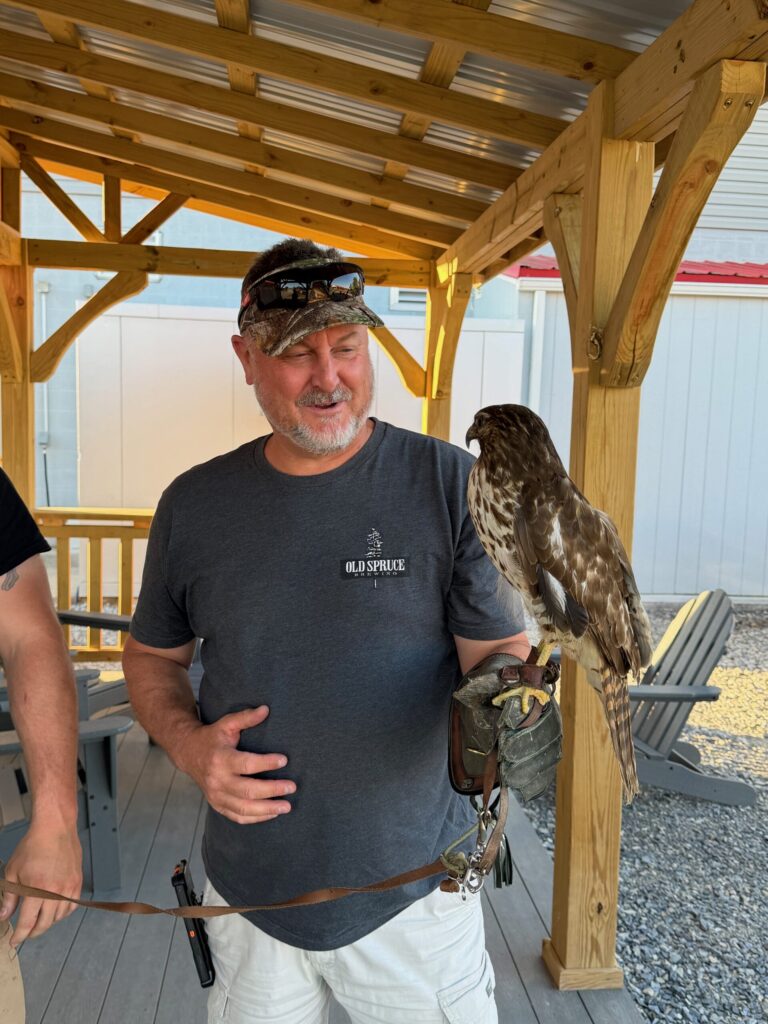 My husband holding the red tailed hawk. He loves birds and especially hawks.
